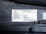 a close up of a car ' s engine compartment with a sticker on it
