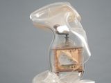 a glass bottle with a clock in it on a pedestal
