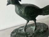 a statue of a bird that is on a table
