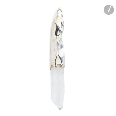 a silver pendant with a picture of a woman on a surfboard