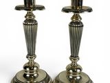 pair of silver candlesticks on a white background