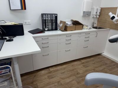 an image of a dentist ' s office with a desk and chair