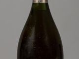 an image of a bottle of champagne on a white table