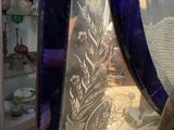 a glass sculpture of a bird on display in a glass case