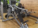 gym equipment in a gym with a wooden floor and a wooden wall