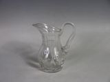 a glass pitcher that is sitting on a table