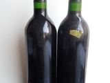 two bottles of wine that are sitting on a table