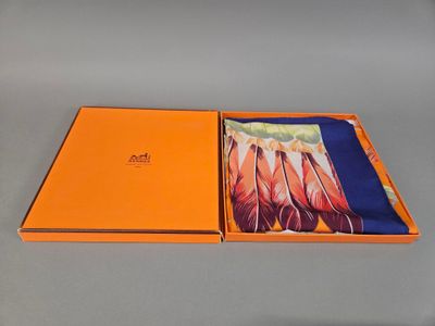 an orange box with a picture of feathers in it on a table