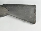 an old gun on a white surface with a white background