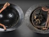 two helmets that are sitting on top of each other on a table