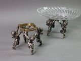 two silver figurines that are sitting on a table