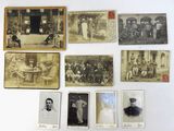 several old black and white photographs of men and women on a table