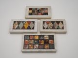 four pieces of art are displayed on a white surface