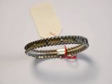 silver and gold bracelet with a tag attached to it on a white surface