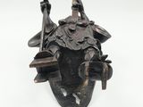 an image of a statue of a man with a bird on his head