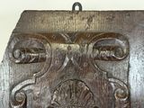 a close up of a wooden plaque with a clock on it