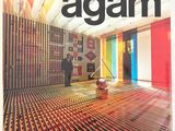 the front cover of a magazine with a man standing in a room