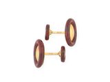 two pairs of red and gold cufflinks on a white background