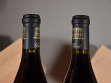 two bottles of wine that are sitting on a table