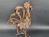 a sculpture of a rooster made of wood on a table