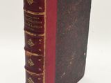 a close up of a book on a white surface with a white background