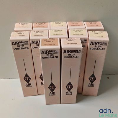 quatre boîtes de pinceaux pour aérographe posées sur une table