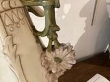 a vase with a flower in it sitting on a table