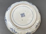 a blue and white plate with a blue design on it