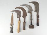 several different types of knives are lined up on a white surface