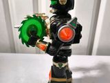 a toy figure of a black and green robot holding a green light