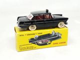 a black toy car sitting on top of a yellow box