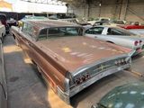 many old cars parked in a garage with other cars