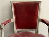 a red chair that is sitting in the corner of a room