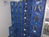 many blue crates stacked on top of each other in a room