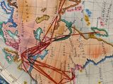 an old map of the world with a compass on top of it