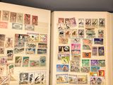 an open book with stamps on it on a table