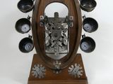 a wooden clock that is on a stand on a white background