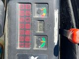 a close up of a clock on the back of a motorcycle