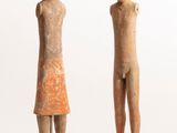 two statues of a man and a woman standing next to each other