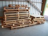 a pile of pallets sitting in front of a building