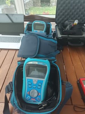 a laptop, a cell phone, and other electronics on a table
