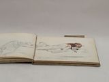 an open book with a drawing of a woman laying on a bed