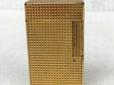 a gold plated cigarette case with a cigarette in the middle