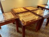 four tables that are sitting on a tiled floor