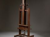 an artist ' s easel with a wooden frame on wheels