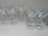 many wine glasses lined up on a white table