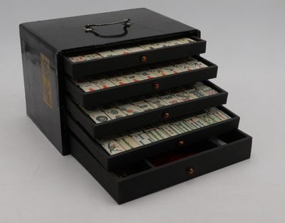 a black box with five drawers full of money