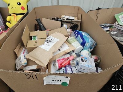 a cardboard box filled with various items and a stuffed animal