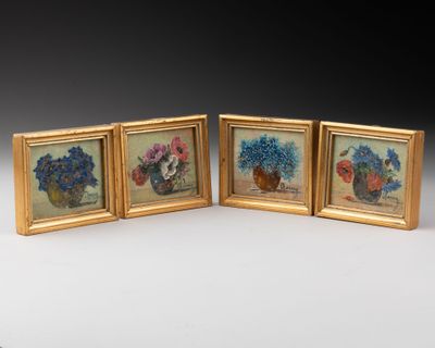 three framed pictures of flowers in vases on a table
