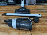 two vacuums sitting on a wooden table next to each other